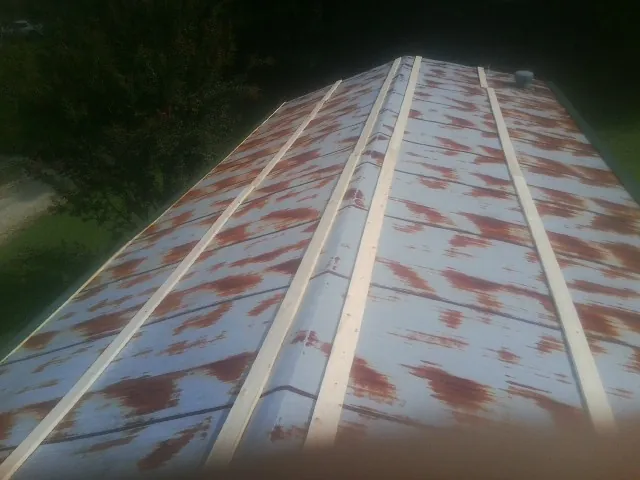 Rusted metal roof panels with new wood purlins before replacement — Storm Damage Roof Repair in Hansen by Roofing Brothers